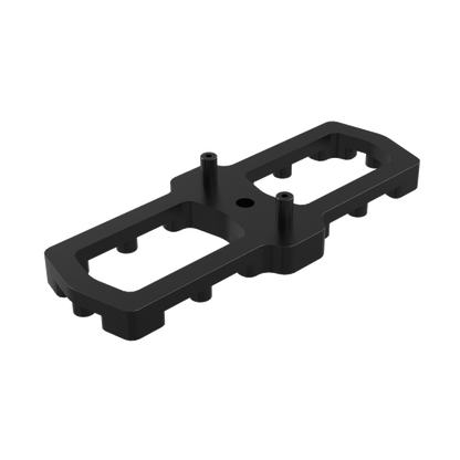 Composant plastique noir rectangulaire avec découpes et deux plots cylindriques, référence ou marque non lisible, présenté sur fond blanc neutre.